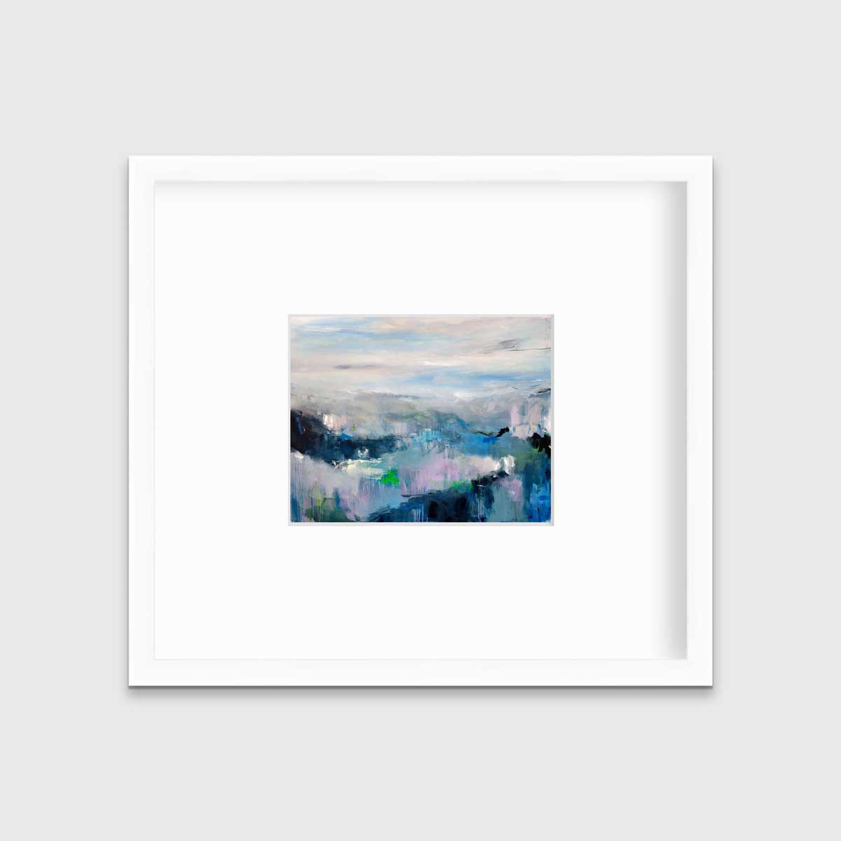 A blue abstract landscape by Kelly Rossetti in a white frame with a mat hangs on a white wall.