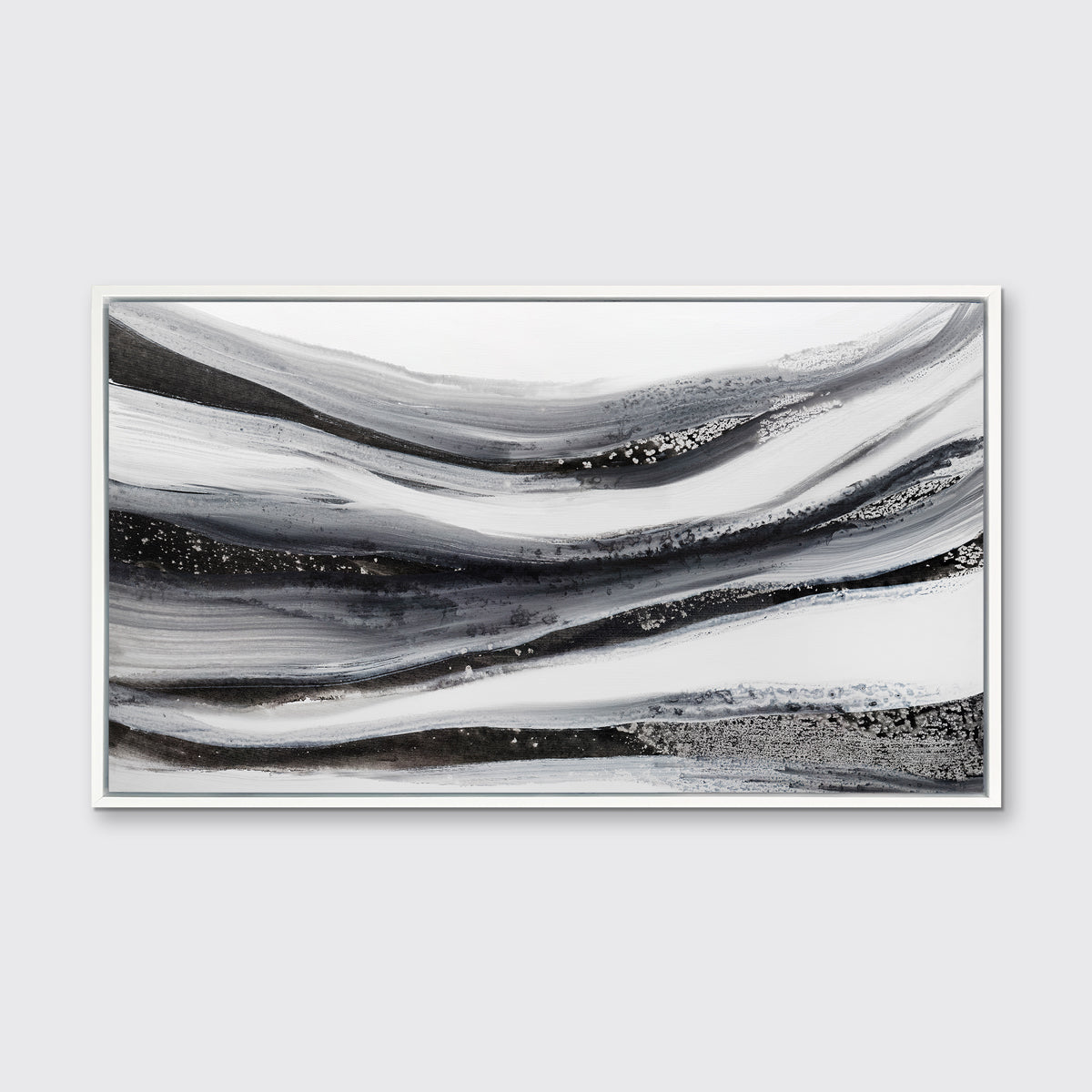 A black, white and grey abstract print in a white floater frame hangs on a white wall.