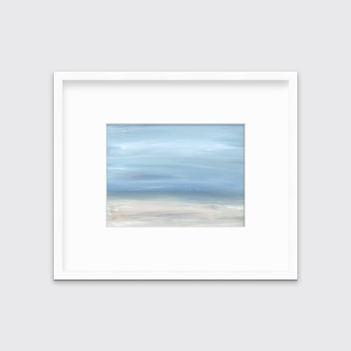 A white, blue and beige abstract seascape print in a white frame with a mat hangs on a white wall.