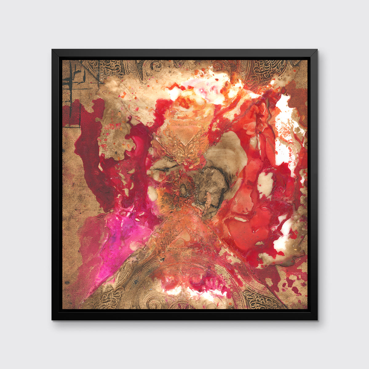A gold, red and pink abstract print in a black floater frame hangs on a white wall.