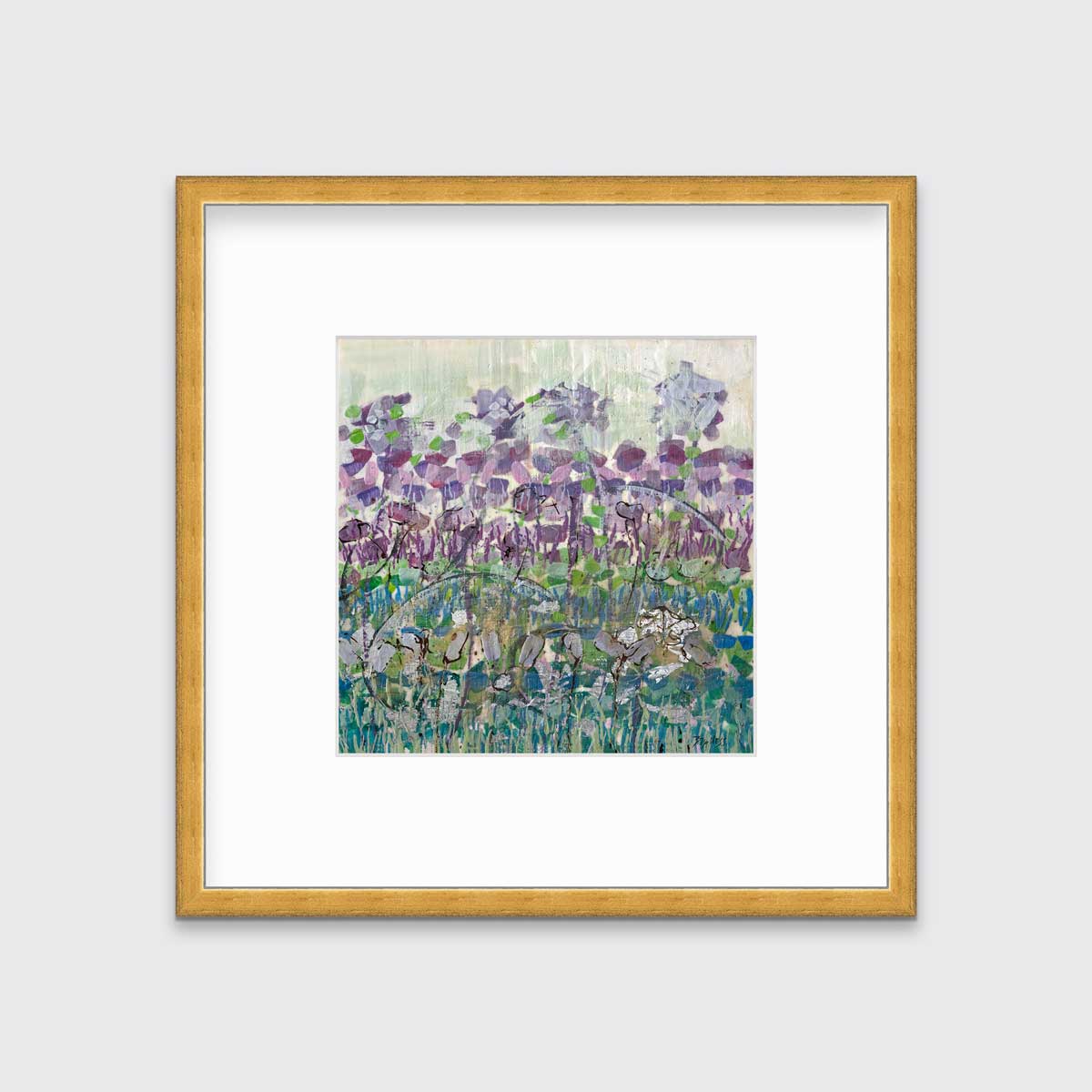 A purple, blue and green abstract floral print in a gold frame with a mat hangs on a white wall.