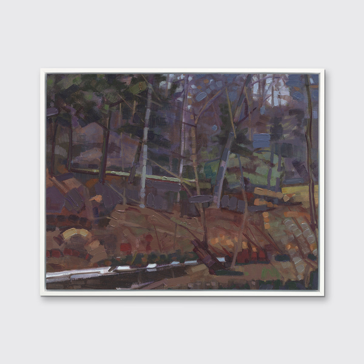 A brown, grey and green abstract landscape print in a white floater frame hangs on a white wall.