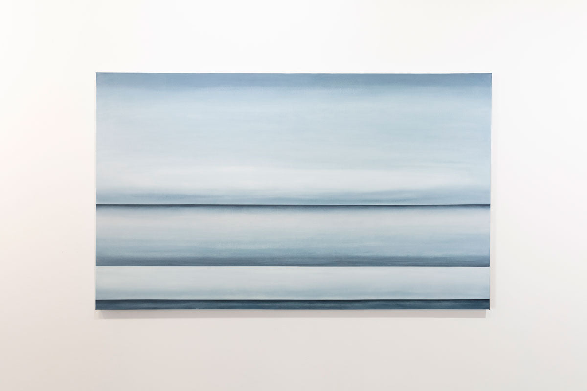 A blue oil painting with multiple navy lines dividing the canvas that suggest horizon lines is hanging on a gallery wall. Wired and ready to hang.