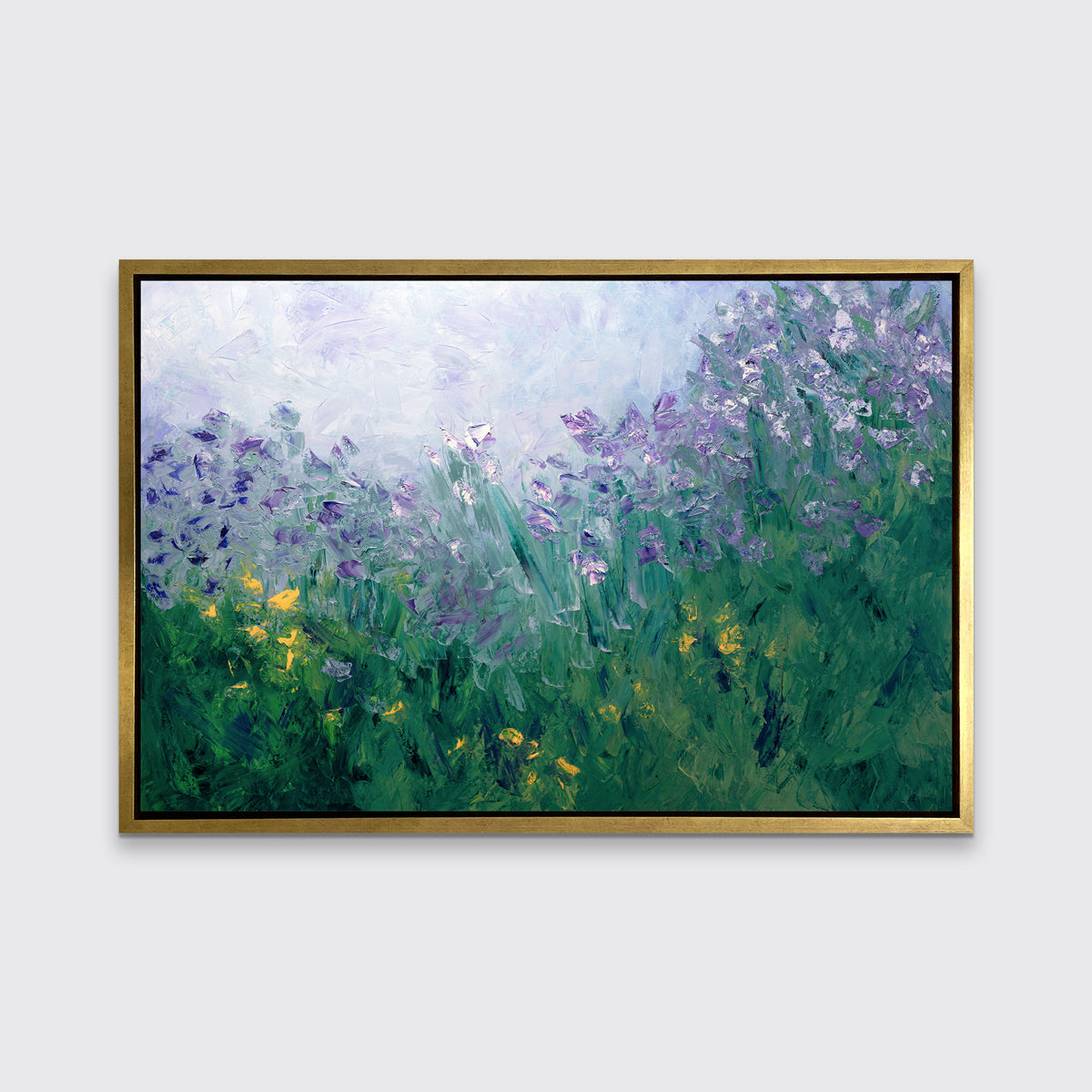 A blue, purple and green abstract print in a gold floater frame hangs on a white wall.