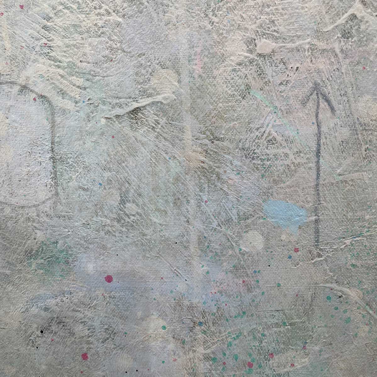 A close up view of texture, white paint and multicolored accents and an arrow design.