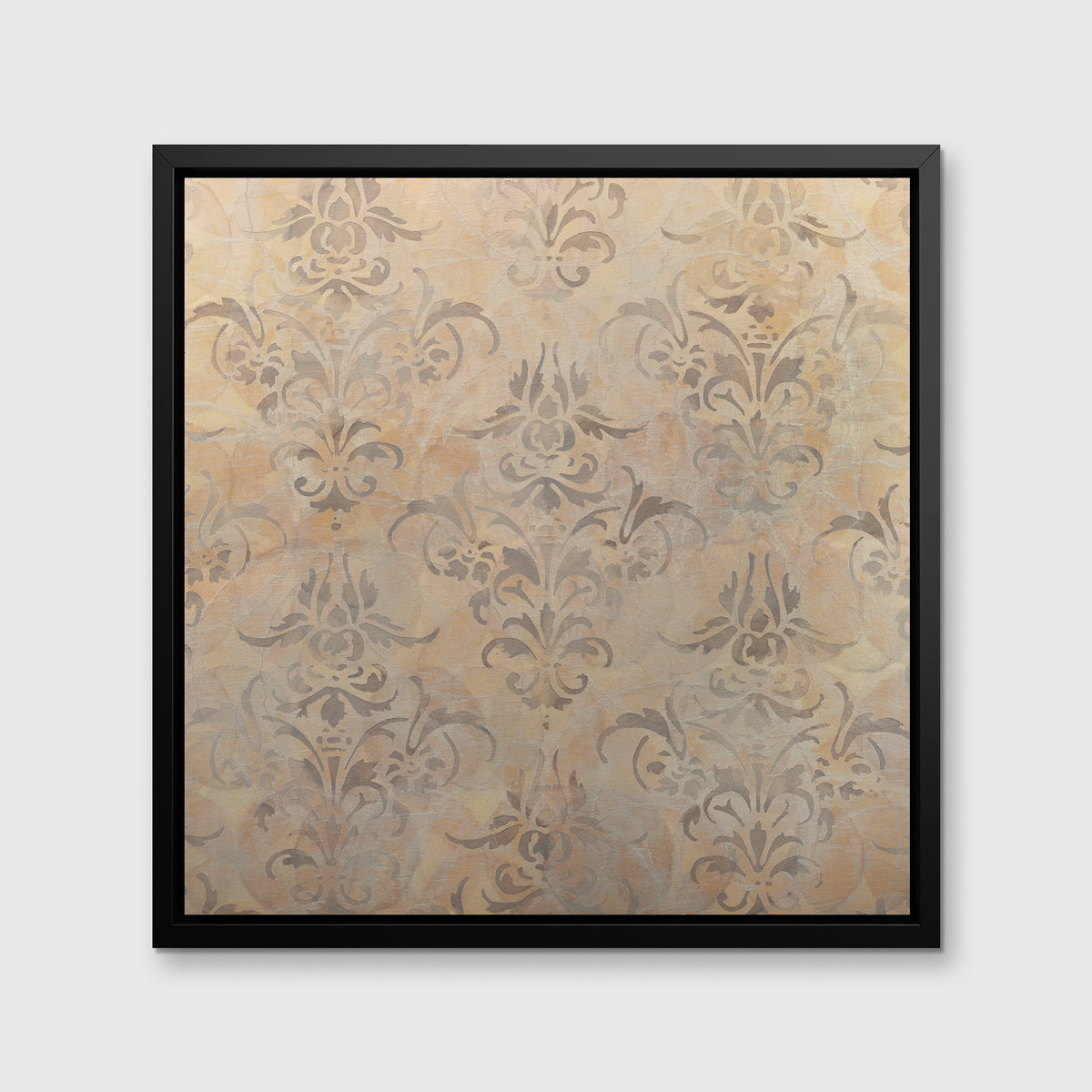A light gold and silver abstract print in a black floater frame hangs on a white wall.