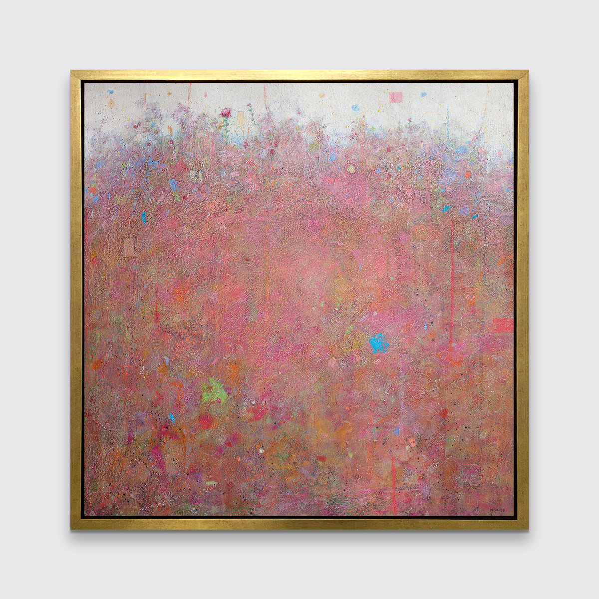 A red abstract landscape print in a gold floater frame hangs on a white wall.