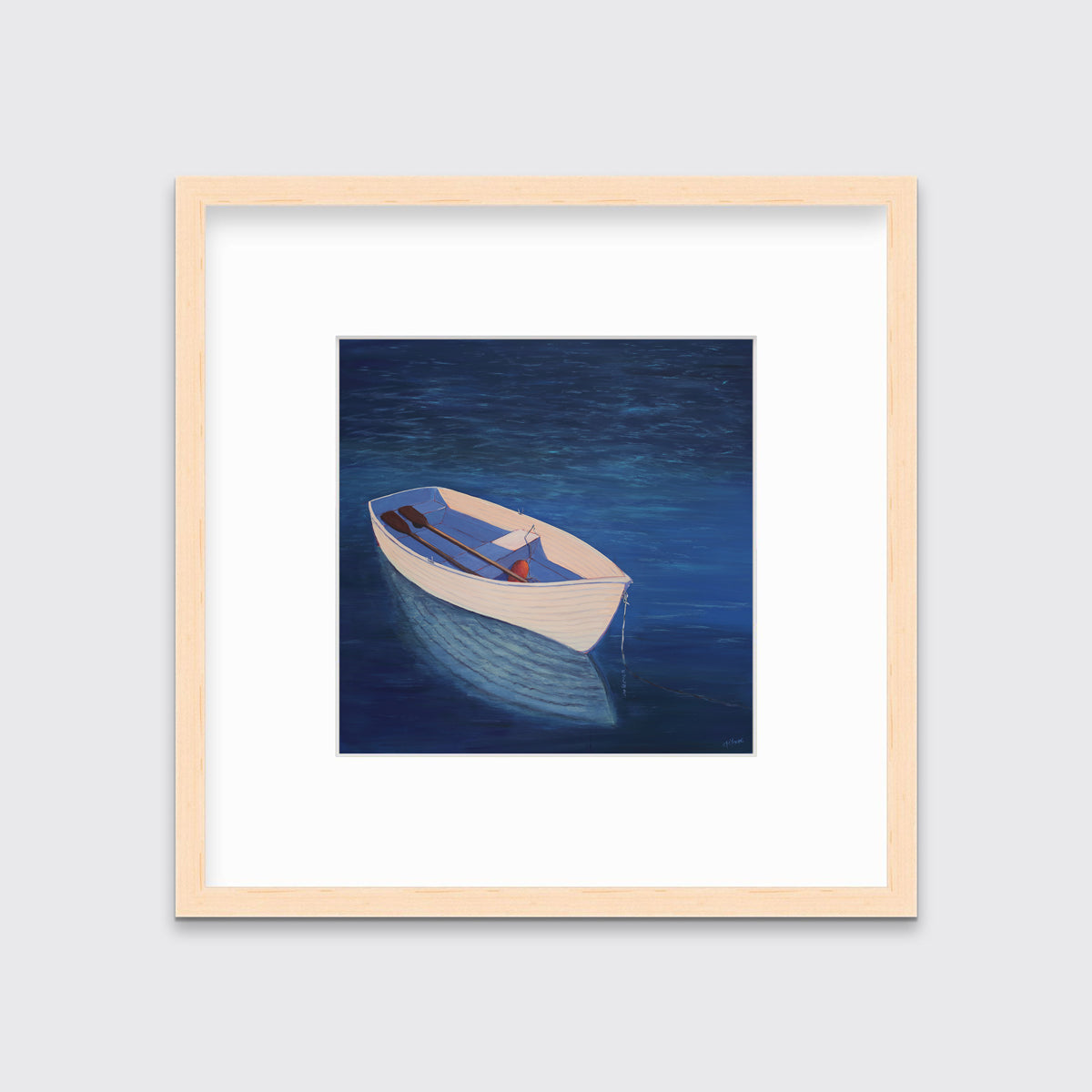 A blue, beige and lavender contemporary coastal print of a boat wading in the water in a natural wood frame with a mat hangs on a white wall.