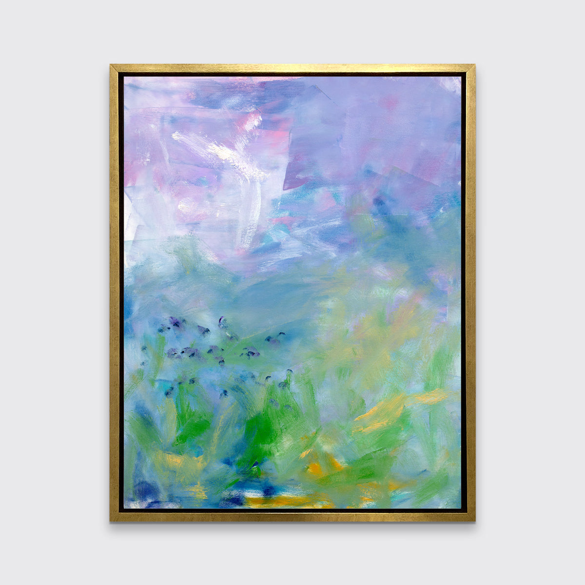 A blue, purple and green abstract print in a gold floater frame hangs on a white wall.