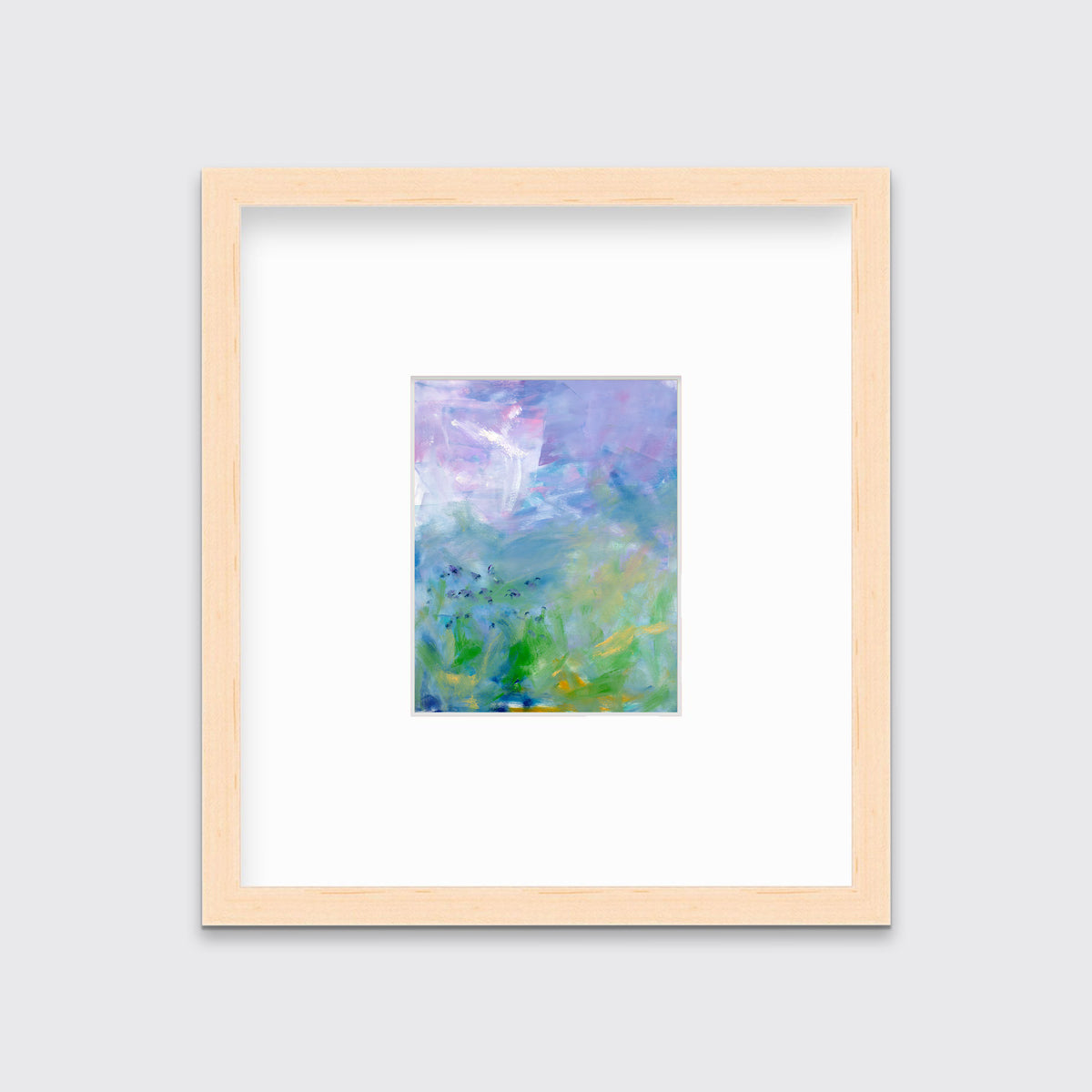 A blue, purple and green abstract print in a natural wood frame with a mat hangs on a white wall.