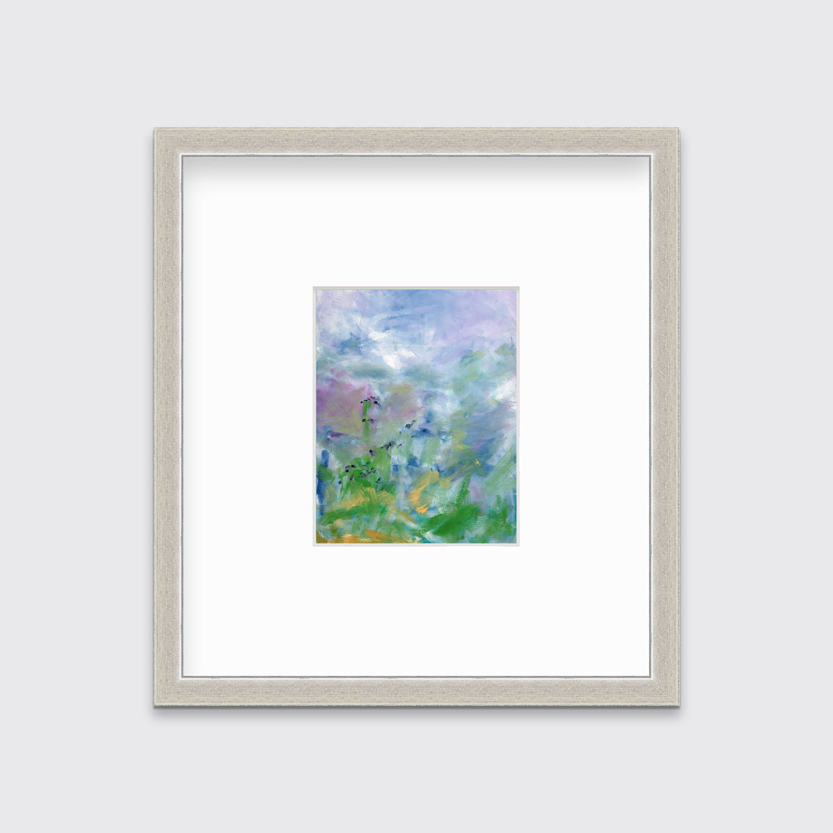 A blue, purple and green abstract print in a silver frame with a mat hangs on a white wall.