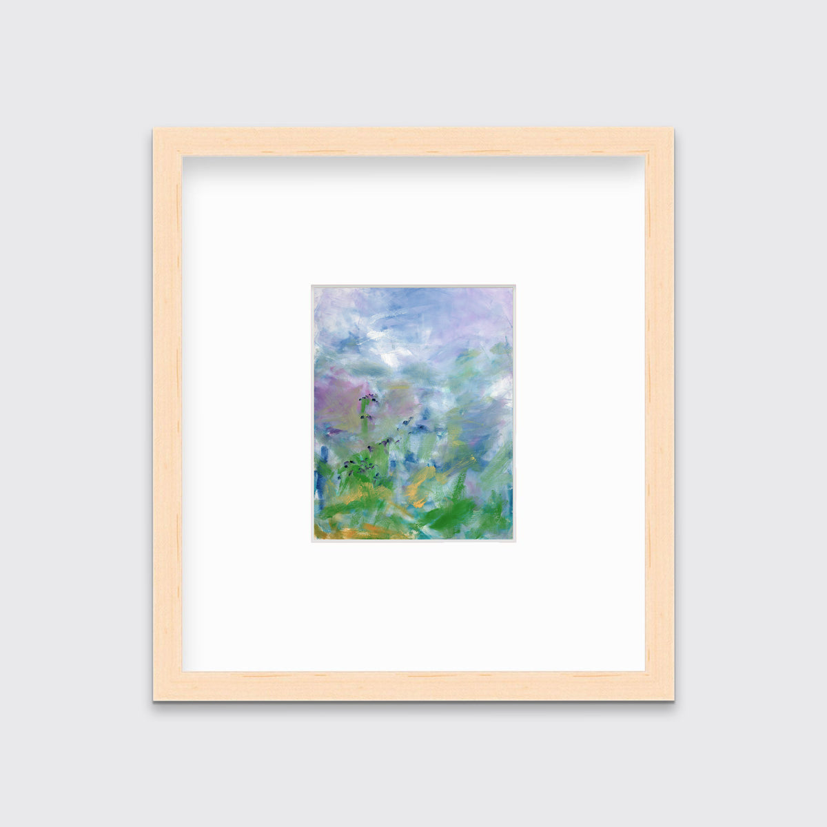 A blue, purple and green abstract print in a natural wood frame with a mat hangs on a white wall.