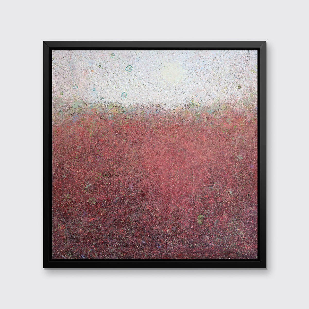 A red abstract landscape print in a black floater frame hangs on a white wall.