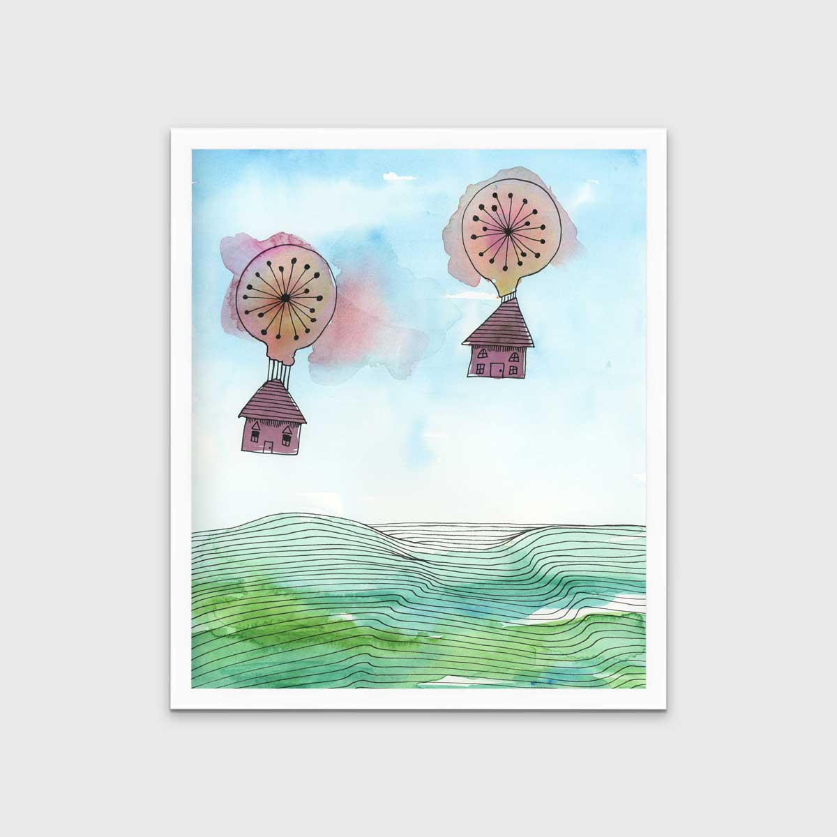 A hot air balloon and house illustration print in an unmatted white frame hangs on a light grey wall.
