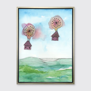 A hot air balloon and house illustration print in a silver floater frame hangs on a light grey wall.