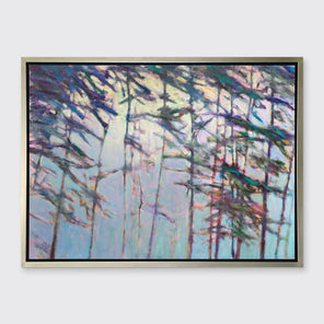 A light blue, green and dark green abstract tree landscape print in a silver floater frame hangs on a white wall.
