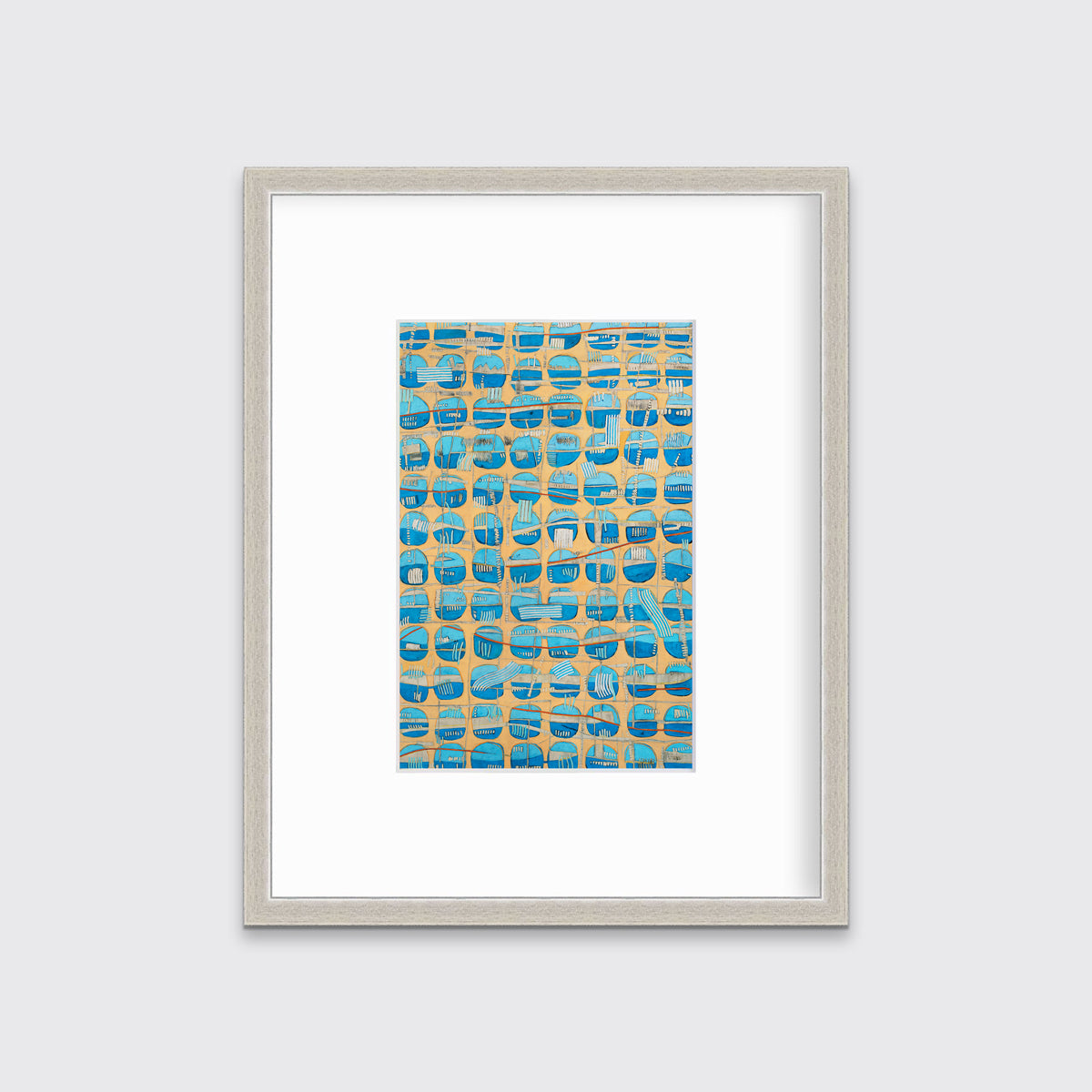 An orange, blue and light blue abstract print in a silver frame with a mat hangs on a white wall.