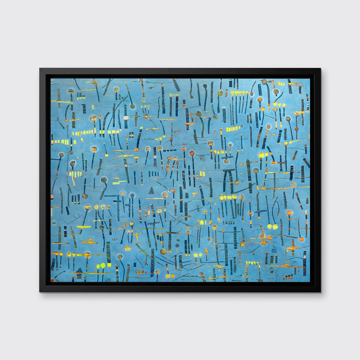 A blue, yellow and orange abstract print in a black floater frame hangs on a white wall.
