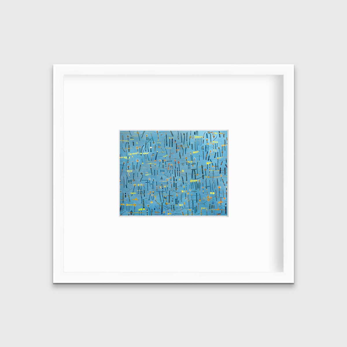 A blue, yellow and orange abstract print in a white frame with a mat hangs on a white wall.