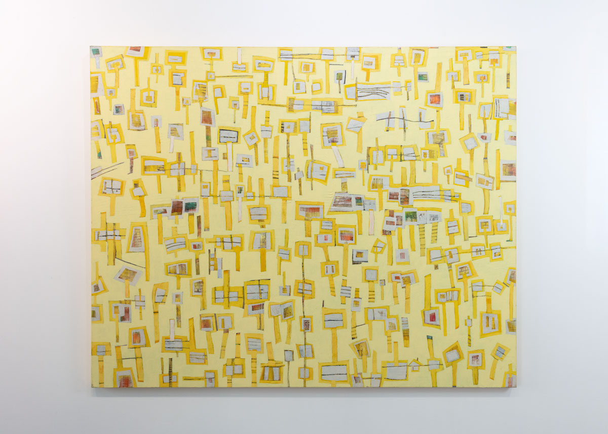 An abstract painting of yellow "lollipops" on a yellow background is hung on a gallery wall.