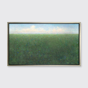 A green, light blue and white abstract landscape print in a silver floater frame hangs on a white wall.