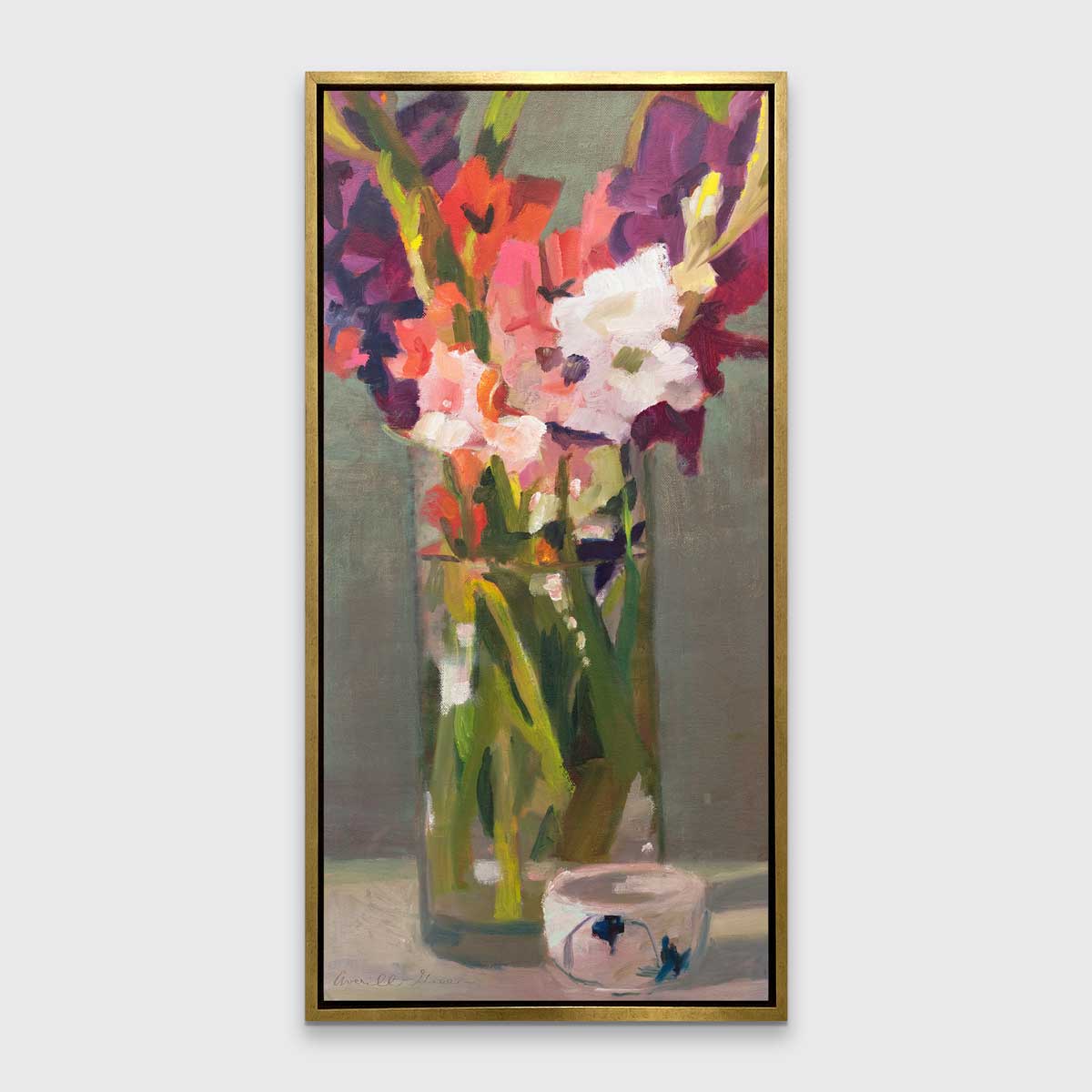A purple, pink and green abstract floral print in a gold floater frame hangs on a white wall.