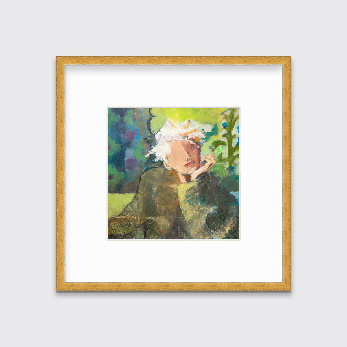 A green, beige and white abstract figural print in a gold frame with a mat hangs on a white wall.