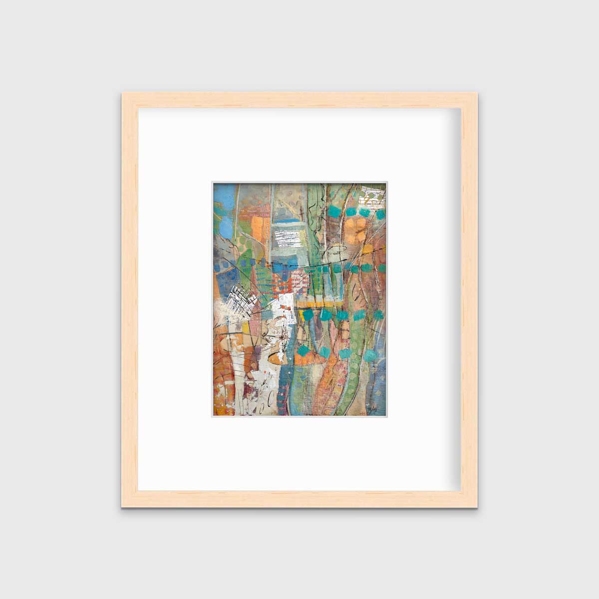 An abstract multicolored print in a natural wood frame with a mat hangs on a white wall.