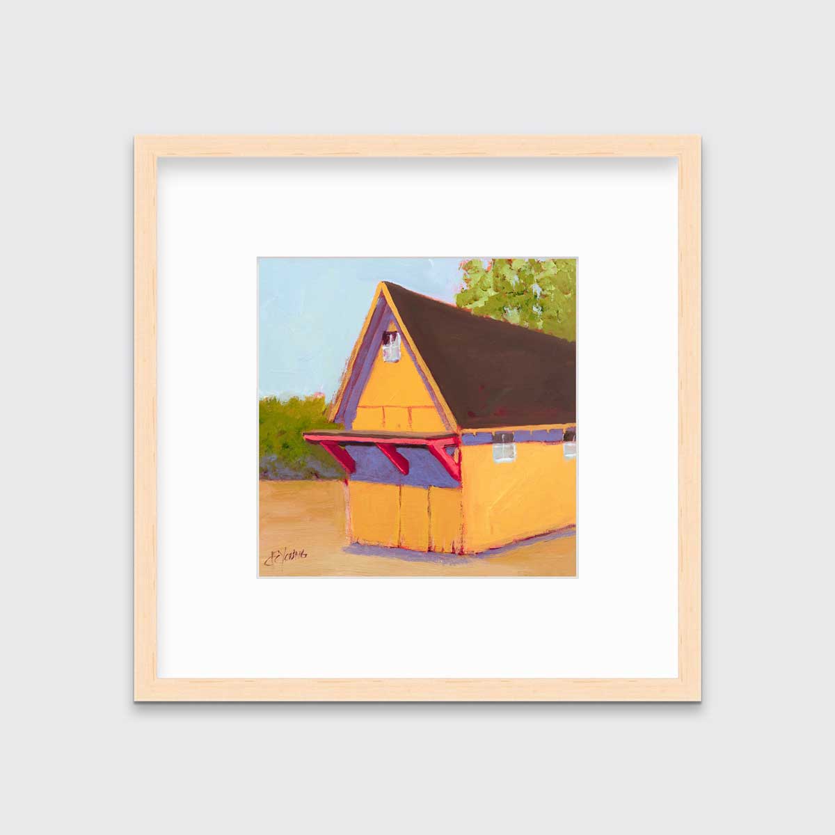 A yellow, orange, lavender and blue contemporary barn print in a natural wood frame with a mat hangs on a white wall.
