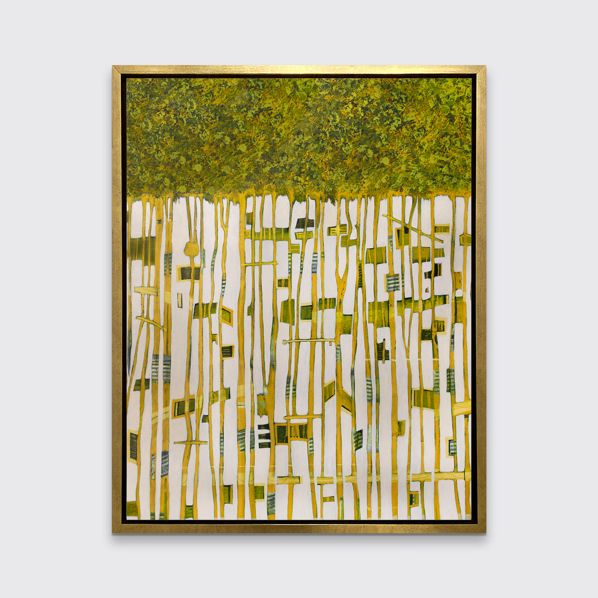 A green, yellow and white abstract print in a gold floater frame hangs on a white wall.