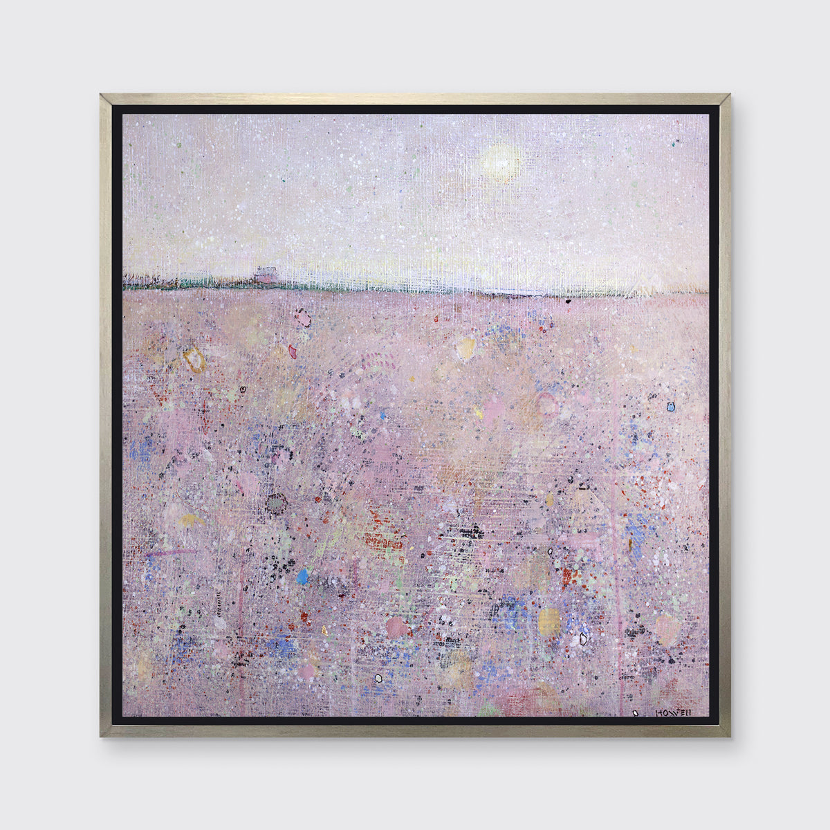 A pink abstract landscape print in a silver floater frame hangs on a white wall.