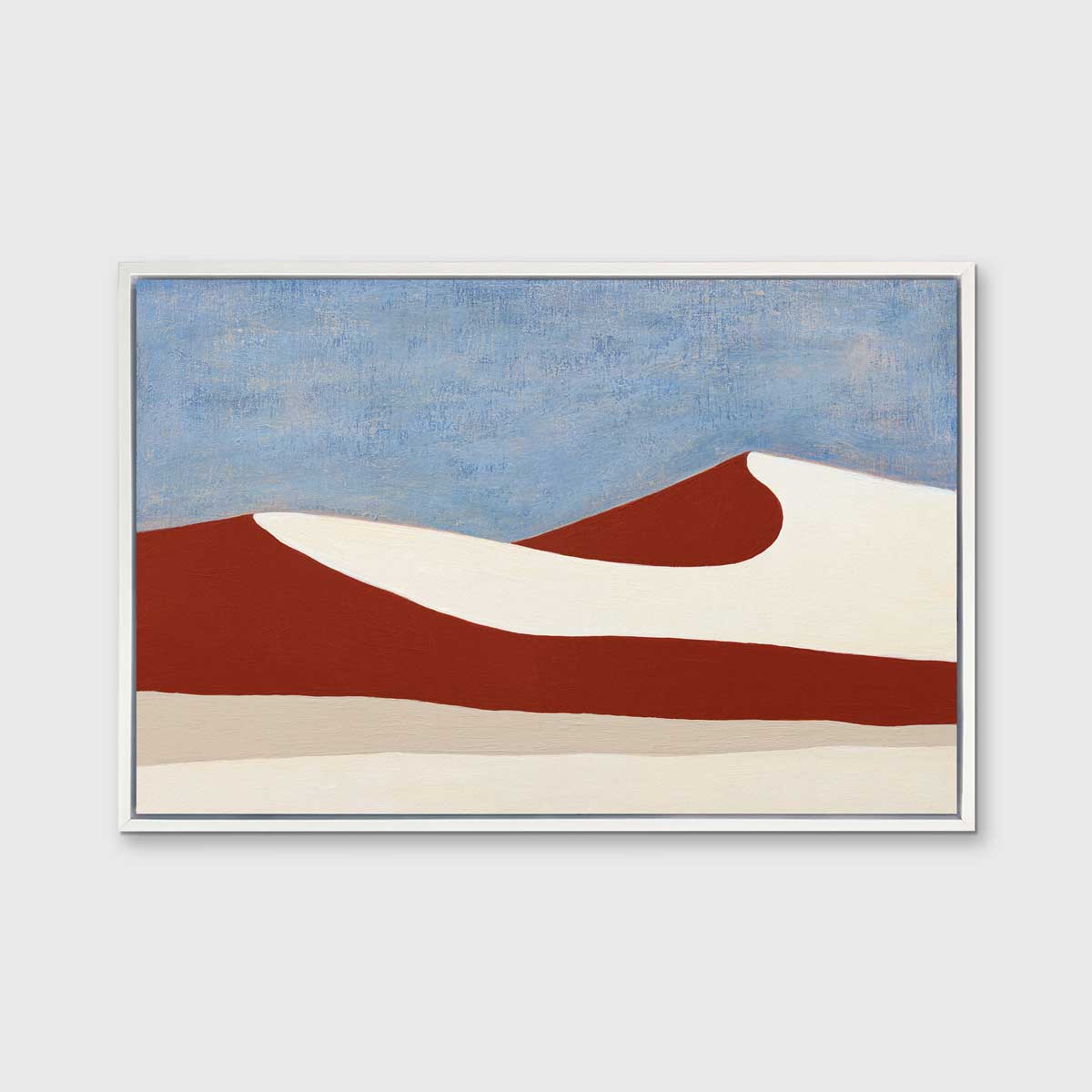 A blue, red and beige abstract landscape print in a white floater frame hangs on a white wall.