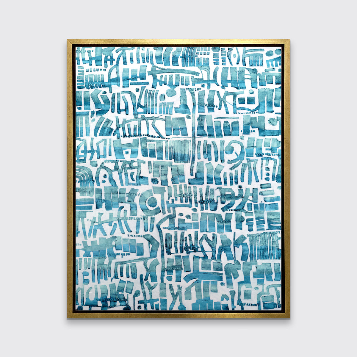 A teal and white abstract shapes print in a gold floater frame hangs on a white wall.