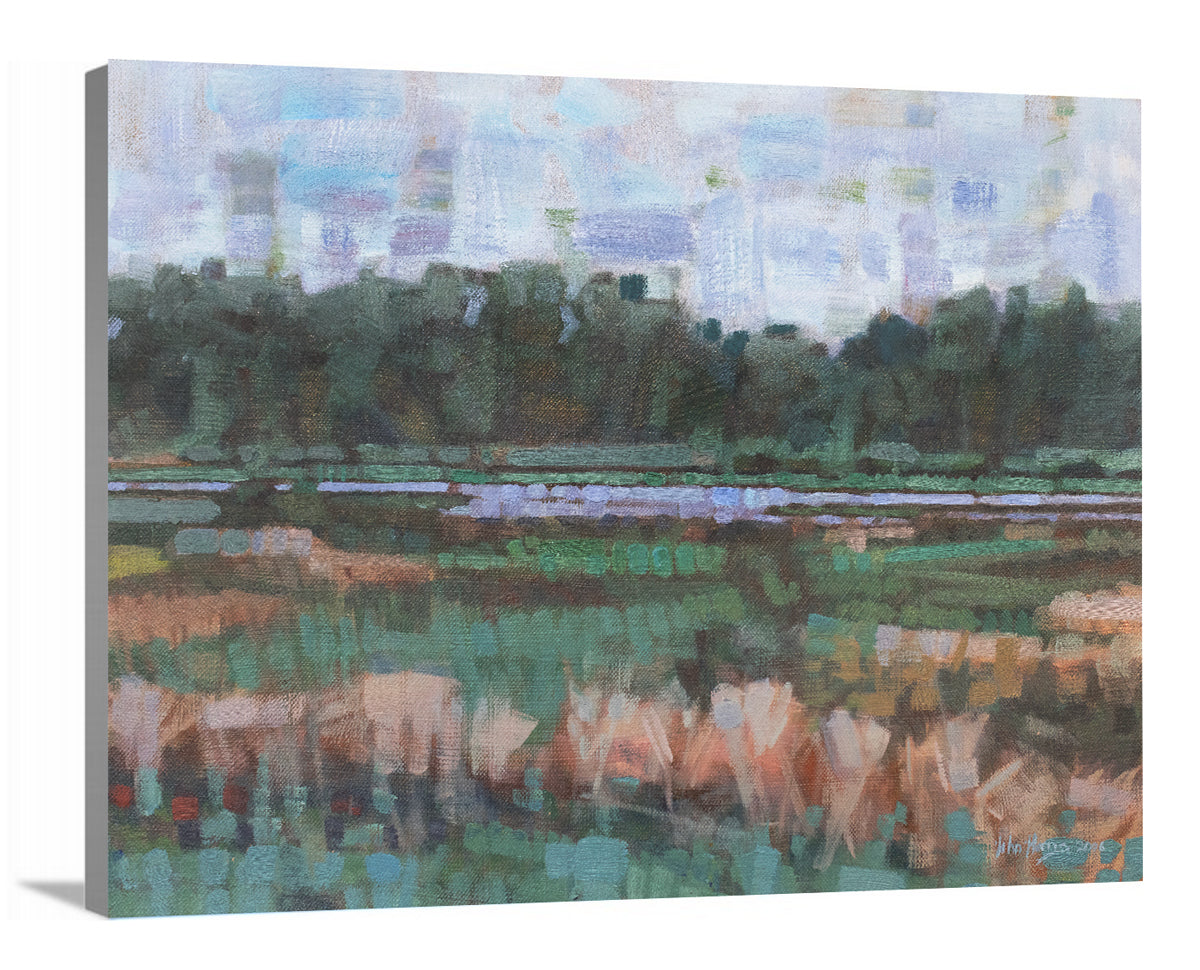 A side-angle view of a green, orange and blue abstract landscape print on canvas.