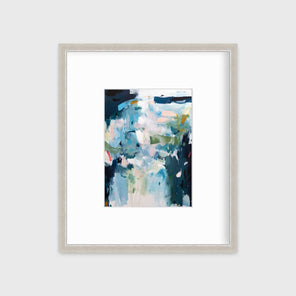 A blue abstract print by Kelly Rossetti in a silver frame with a mat hangs on a white wall.