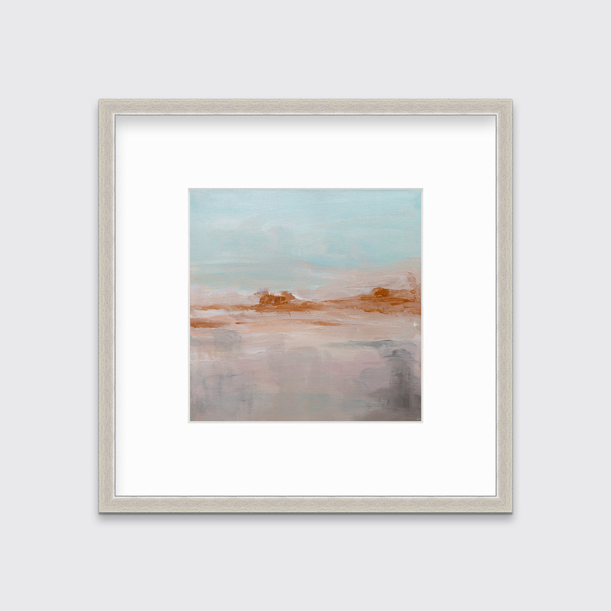 A teal, copper and dusty pink abstract print in a silver frame with a mat hangs on a white wall.