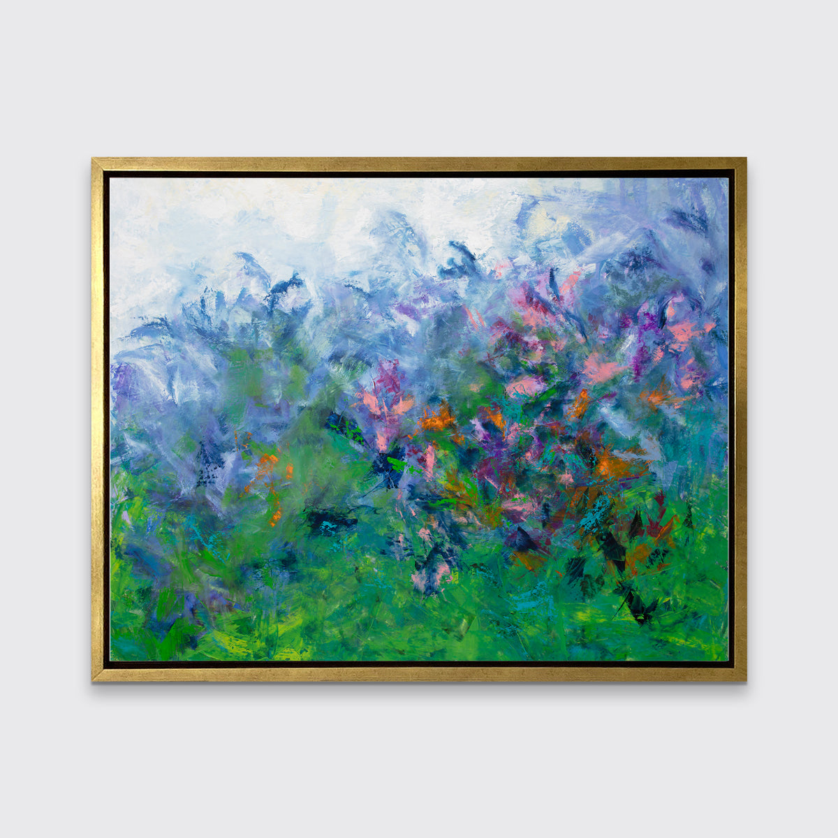 A multicolored abstract floral print in a gold floater frame hangs on a white wall.