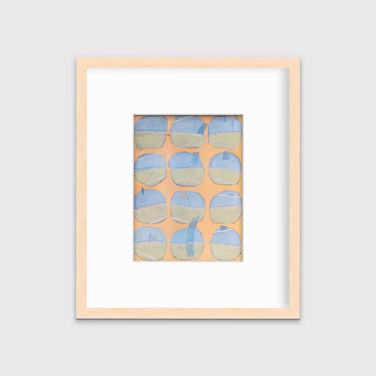 A orange, blue, green and white abstract print in a natural wood frame with a mat hangs on a white wall.