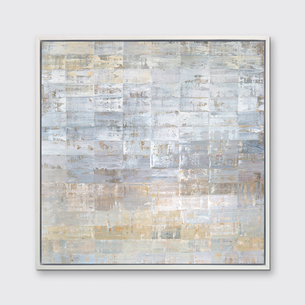 A grey, silver and light gold abstract geometric print in a white floater frame hangs on a white wall.