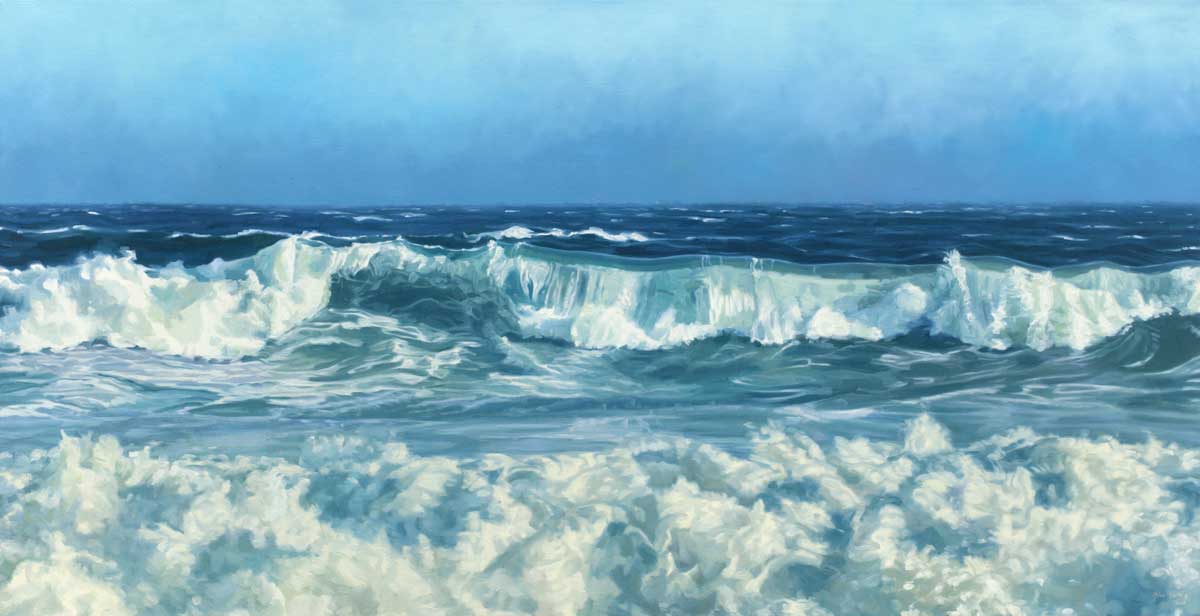 Blue and white waves roll forward toward you, foam is the foreground, gradient blue sky in the background.