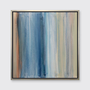 A blue, white, orange and light green abstract print in a silver floater frame hangs on a white wall.