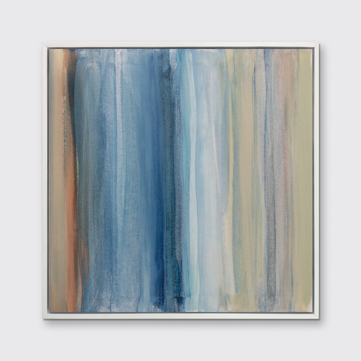 A blue, white, orange and light green abstract print in a white floater frame hangs on a white wall.