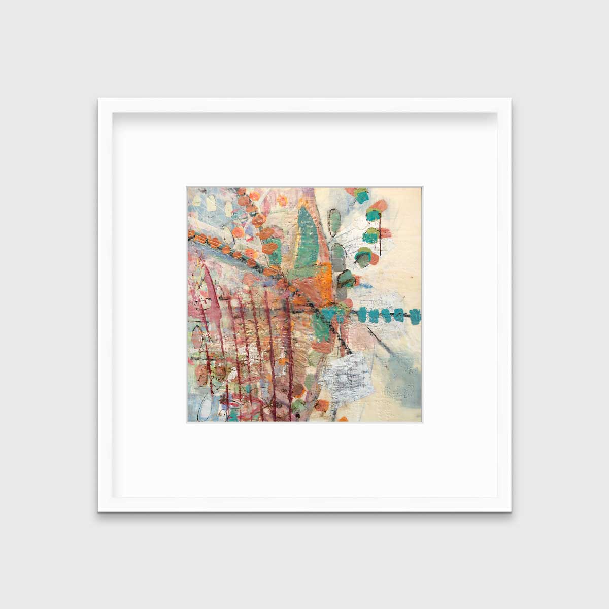 A multicolored abstract print in a white frame with a mat hangs on a white wall.