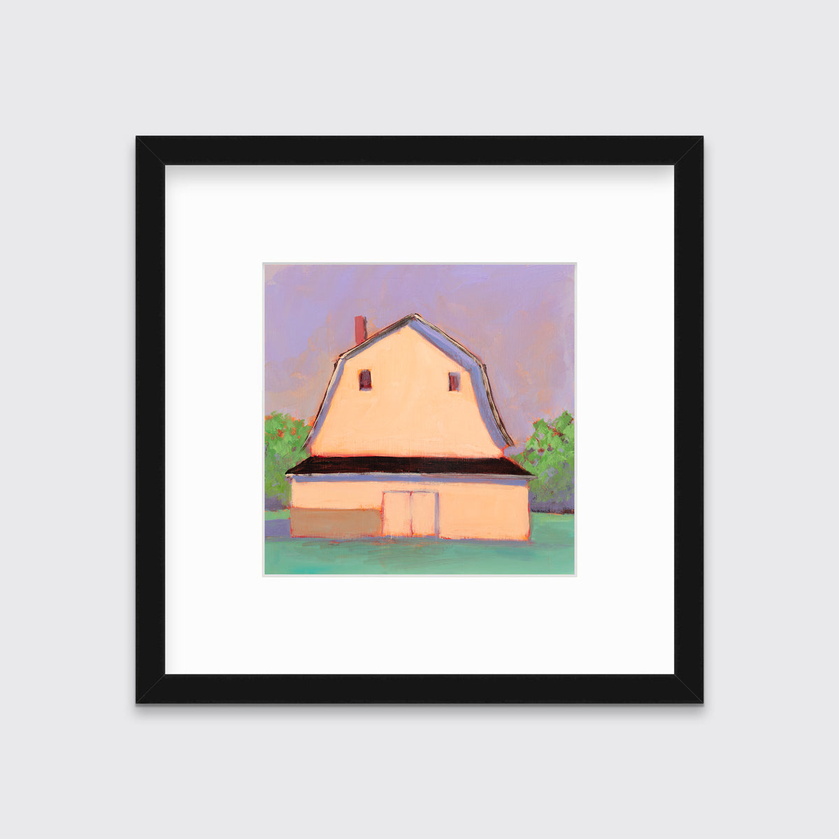 A print of a light orange barn, a lavender sky, green bushes and a teal ground in a black frame with a mat hangs on a white wall.