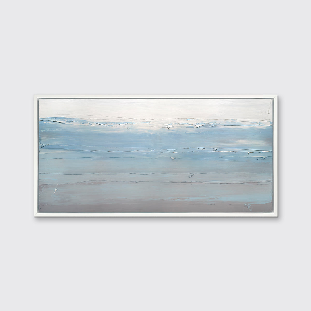 A blue, grey and grey-beige abstract print in a white floater frame hangs on a white wall.