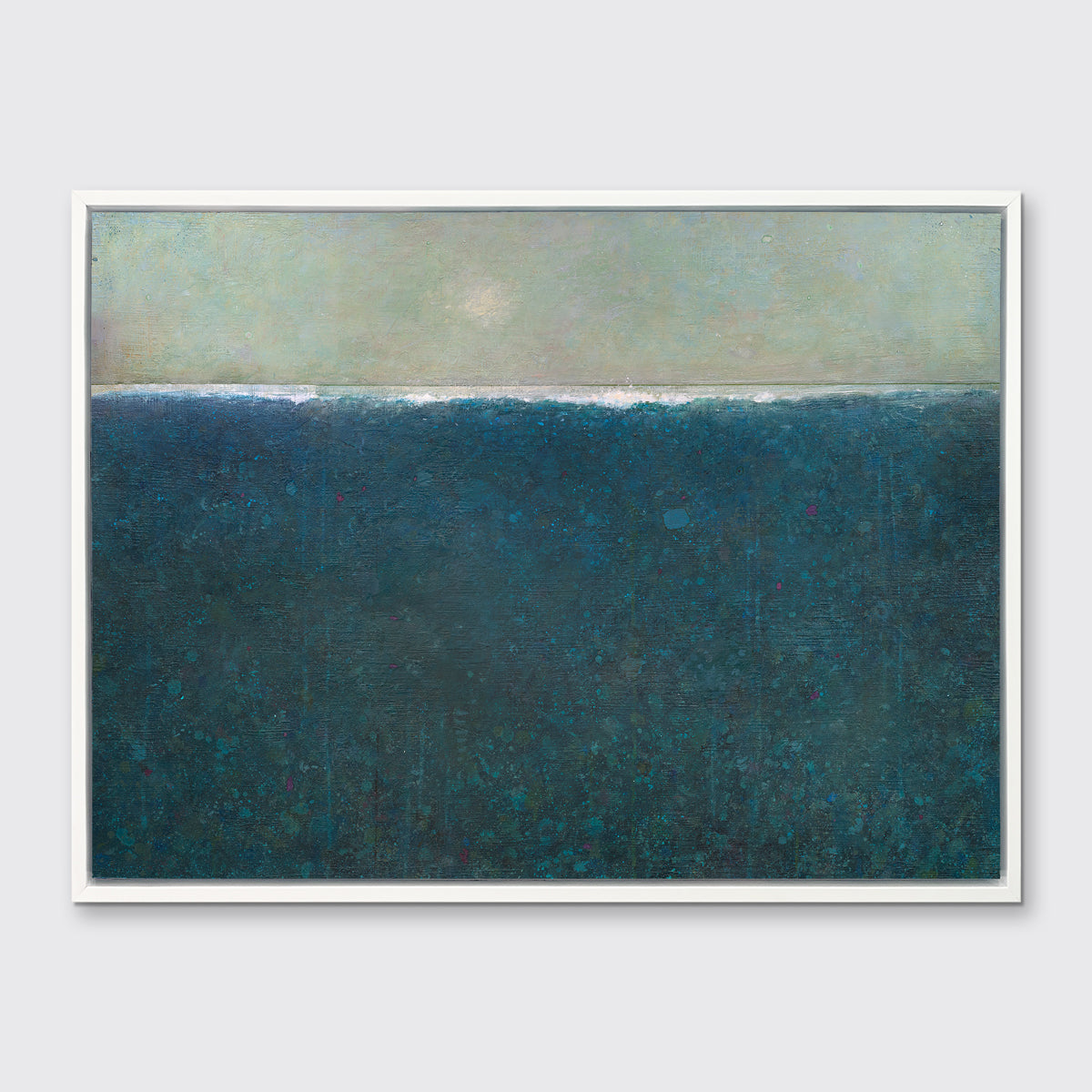 A deep blue abstract landscape print in a white floater frame hangs on a white wall.
