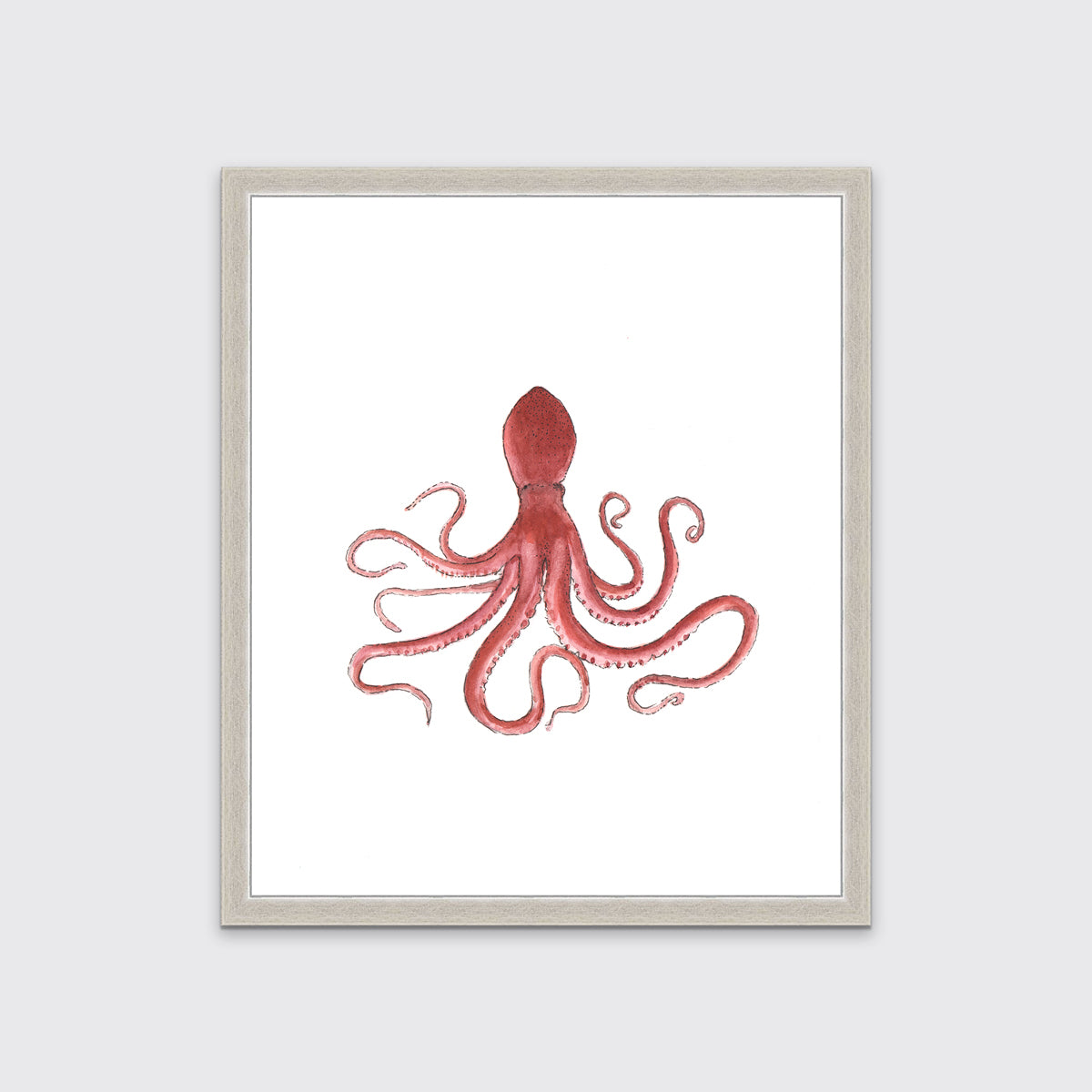 A pink octopus print in an unmatted silver frame hangs on a white wall.