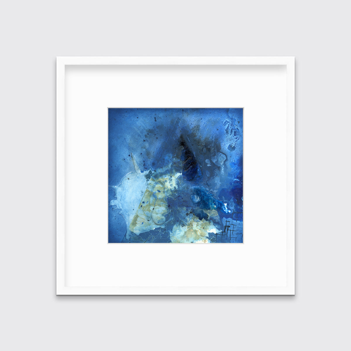 A blue, green and black abstract print in a white frame with a mat hangs on a white wall.