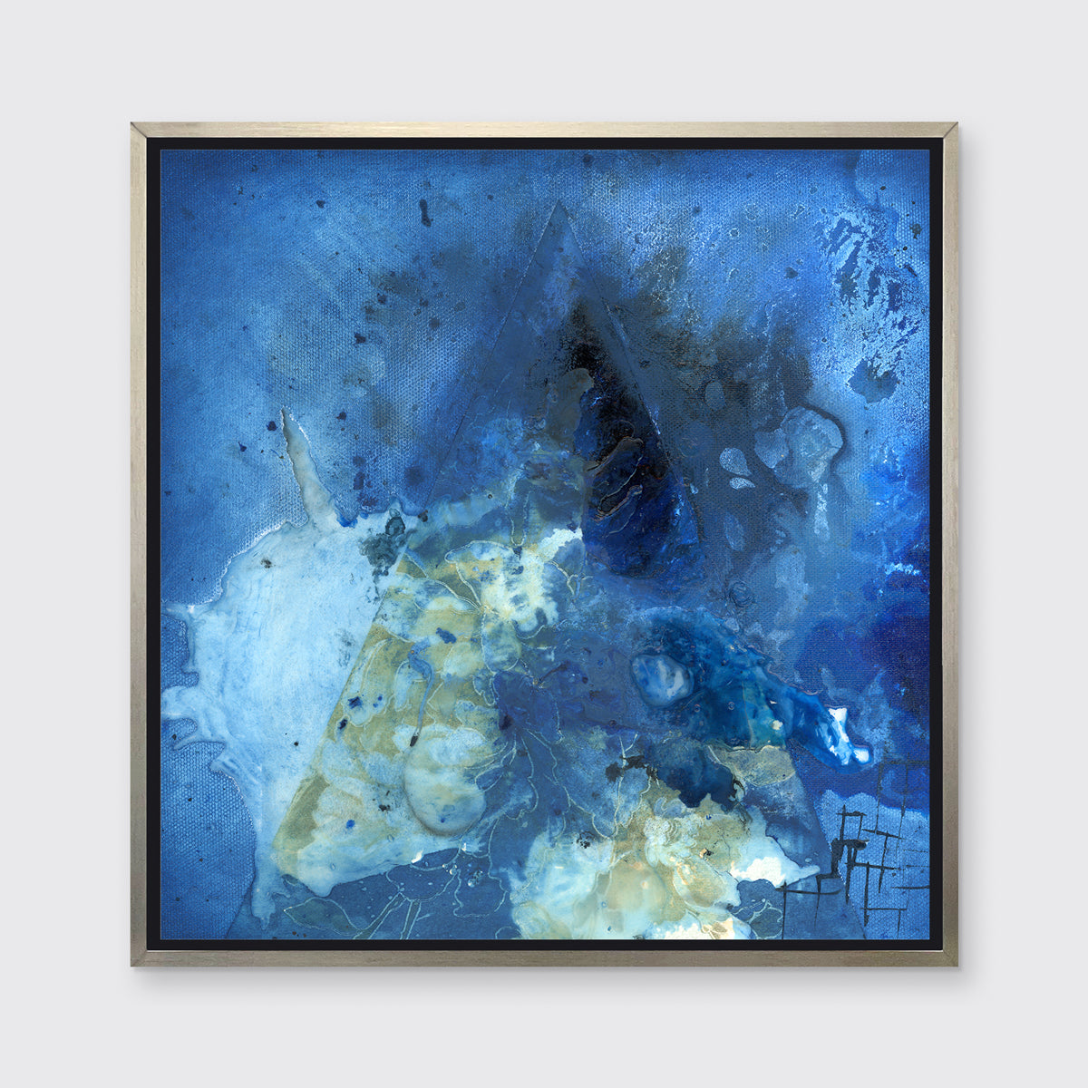 A blue, green and black abstract print in a silver floater frame hangs on a white wall.