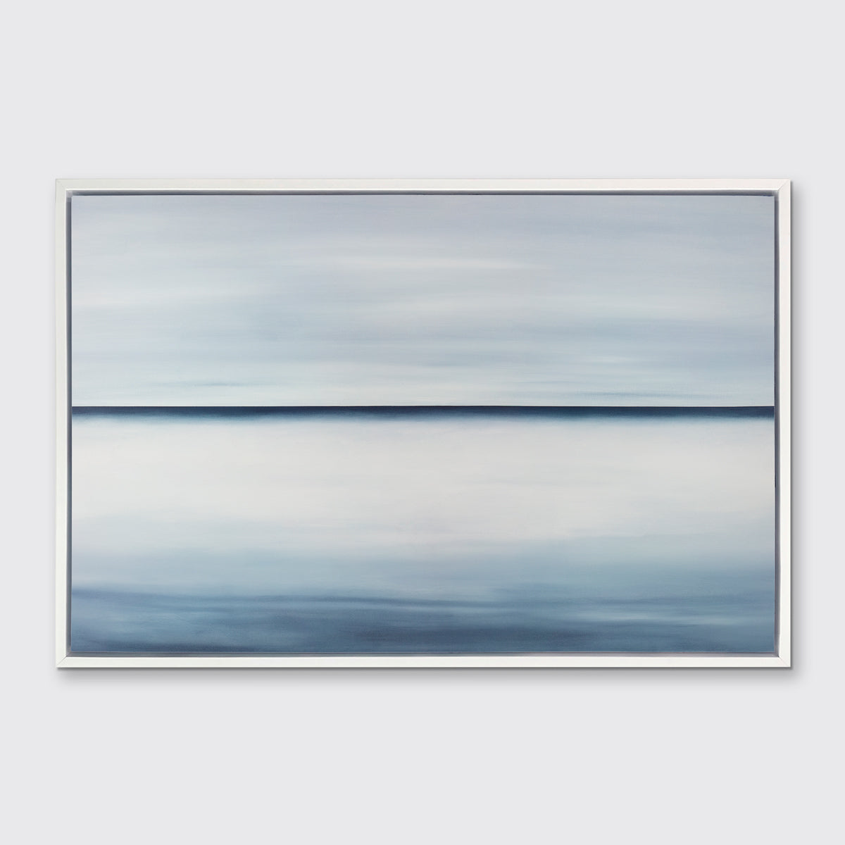 A tonal blue abstract landscape print in a white floater frame hangs on a white wall.